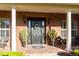Close-up of a welcoming brick front porch with elegant columns and decor at 5789 Lake Victoria Dr, Lakeland, FL 33813