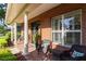 Inviting brick front porch with seating, columns, and manicured landscaping at 5789 Lake Victoria Dr, Lakeland, FL 33813