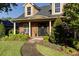 Inviting brick front porch with elegant columns, seating, and lush landscaping at 5789 Lake Victoria Dr, Lakeland, FL 33813