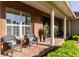 Inviting brick front porch with seating, columns, and manicured landscaping at 5789 Lake Victoria Dr, Lakeland, FL 33813