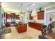 Kitchen with island, stainless steel appliances, granite counters, and wood cabinetry at 5789 Lake Victoria Dr, Lakeland, FL 33813