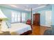 This main bedroom features a four poster bed, plantation shutters, and a dark wood armoire at 5789 Lake Victoria Dr, Lakeland, FL 33813