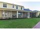 A spacious screened-in porch area with outdoor seating, perfect for relaxing and entertaining overlooking a well maintained lawn at 5789 Lake Victoria Dr, Lakeland, FL 33813