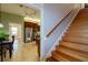 Staircase adjacent to dining room and kitchen with stainless steel appliances and wood cabinets at 5789 Lake Victoria Dr, Lakeland, FL 33813