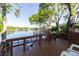 A stunning wooden deck overlooking a tranquil lake, providing a serene outdoor living space with scenic views at 5789 Lake Victoria Dr, Lakeland, FL 33813