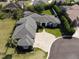 Aerial view of home featuring an expansive lawn, brick driveway, and pristine landscaping at 6470 Ashley Dr, Lakeland, FL 33813