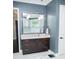 This bathroom features a granite countertop vanity with a large framed mirror and pendant lighting at 6470 Ashley Dr, Lakeland, FL 33813