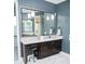 This bathroom features a vanity with granite counters, dark wood cabinetry, and a seated makeup area at 6470 Ashley Dr, Lakeland, FL 33813