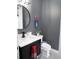 Modern bathroom with a round mirror, marble countertop, and gray walls at 6470 Ashley Dr, Lakeland, FL 33813