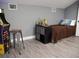 Bedroom featuring gray walls, laminate floors, and a Pac-Personal arcade game at 6470 Ashley Dr, Lakeland, FL 33813