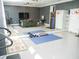 Exercise room featuring mirrored walls, exercise equipment, and a lounge area at 6470 Ashley Dr, Lakeland, FL 33813