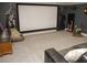 Home theater features a projection screen, dark walls, movie character images, and comfortable seating at 6470 Ashley Dr, Lakeland, FL 33813