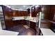 Modern kitchen with dark wood cabinetry, stainless steel appliances, and a sleek white backsplash at 6470 Ashley Dr, Lakeland, FL 33813