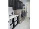 Efficient laundry area with a new washer and dryer, built-in shelving, and ample counter space for folding at 6470 Ashley Dr, Lakeland, FL 33813