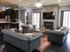 Elegant living room boasts a stone fireplace, comfortable seating, and an open floor plan with hardwood floors at 6470 Ashley Dr, Lakeland, FL 33813