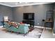 Living room featuring a modern entertainment center and a comfortable couch at 6470 Ashley Dr, Lakeland, FL 33813