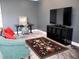 Bright living room with a comfortable couch, a desk, and a modern entertainment center at 6470 Ashley Dr, Lakeland, FL 33813