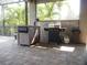 Covered outdoor kitchen area with a built-in grill and bar, offering a great space for entertaining at 6470 Ashley Dr, Lakeland, FL 33813