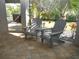 Relaxing outdoor patio with two Adirondack chairs and lush landscaping at 6470 Ashley Dr, Lakeland, FL 33813