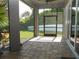 Screened in outdoor patio with stone floor, pet door, and view of backyard at 6470 Ashley Dr, Lakeland, FL 33813