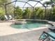 Beautiful screened-in pool and hot tub with lush tropical landscaping create a relaxing outdoor oasis at 6470 Ashley Dr, Lakeland, FL 33813