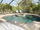 Relaxing screened pool and hot tub area with pavers, tropical landscaping, and covered seating area at 6470 Ashley Dr, Lakeland, FL 33813