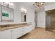 Bathroom featuring double sinks, granite countertops, tile floors, custom cabinetry and glass shower at 6704 Crescent Lake Dr, Lakeland, FL 33813