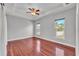 Bright bedroom with hardwood floors, tray ceiling, and large windows offering a scenic view at 6720 Highlands Creek Loop, Lakeland, FL 33813