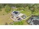 Aerial view of home with metal roof, a two car garage, and wooded backdrop at 6745 Old Melbourne Hwy, St Cloud, FL 34771