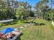 Expansive backyard featuring a fire pit, seating area, and scenic path leading to waterfront at 6745 Old Melbourne Hwy, St Cloud, FL 34771