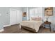Cozy bedroom boasts natural light from a large window and neutral decor at 6745 Old Melbourne Hwy, St Cloud, FL 34771