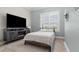 Comfortable bedroom with mounted tv and a large window, creating a relaxing atmosphere at 6745 Old Melbourne Hwy, St Cloud, FL 34771