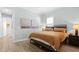 Cozy bedroom with warm colors, hardwood floors, and natural light at 6745 Old Melbourne Hwy, St Cloud, FL 34771
