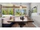 Bright eat-in kitchen featuring a corner bench, wooden table, and views of the wooded back yard at 6745 Old Melbourne Hwy, St Cloud, FL 34771