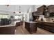 Spacious kitchen featuring dark wood cabinetry, granite countertops, and stainless steel appliances at 6745 Old Melbourne Hwy, St Cloud, FL 34771