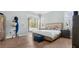 Relaxing main bedroom with patio access, neutral color palette, and light-colored hardwood floors at 6745 Old Melbourne Hwy, St Cloud, FL 34771