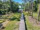 Scenic wooded path leading to a waterfront dock at 6745 Old Melbourne Hwy, St Cloud, FL 34771