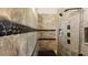 Elegant shower with gray marble tile, stone accents, and multi-spray fixtures at 6745 Old Melbourne Hwy, St Cloud, FL 34771