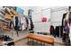 Well-organized walk-in closet with built-in shelving and ample storage space with a bench at 6745 Old Melbourne Hwy, St Cloud, FL 34771