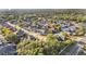 Expansive aerial view showcases a tranquil residential neighborhood with mature trees and well-kept homes at 6774 Crescent Woods Cir, Lakeland, FL 33813