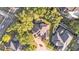 Aerial view of a well-maintained home with a screened-in pool nestled among lush green trees at 6774 Crescent Woods Cir, Lakeland, FL 33813