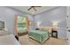Comfortable bedroom with a soft color palette, plush carpeting, and a large window at 6774 Crescent Woods Cir, Lakeland, FL 33813