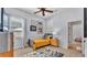 Cozy bedroom with a single bed, ceiling fan and natural light from the window at 6774 Crescent Woods Cir, Lakeland, FL 33813