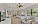 Spacious bedroom featuring multiple beds, ceiling fans, and a large window with tree views at 6774 Crescent Woods Cir, Lakeland, FL 33813