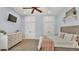 Light blue bedroom featuring a ceiling fan, white closet doors and a shelf with decorative plants at 6774 Crescent Woods Cir, Lakeland, FL 33813