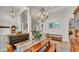 Elegant dining room featuring a decorative chandelier and a long wooden table at 6774 Crescent Woods Cir, Lakeland, FL 33813