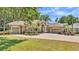 Charming single-story home with stone accents, three-car garage, and a paver driveway at 6774 Crescent Woods Cir, Lakeland, FL 33813