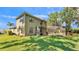 Well-maintained two-story home featuring a screened-in pool area and lush green lawn at 6774 Crescent Woods Cir, Lakeland, FL 33813