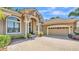 The exterior features an attached garage with a neutral door and beautifully manicured landscaping at 6774 Crescent Woods Cir, Lakeland, FL 33813