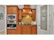 Kitchen with stainless steel oven, stove and a pantry, adjacent to light wooden cabinets at 6774 Crescent Woods Cir, Lakeland, FL 33813